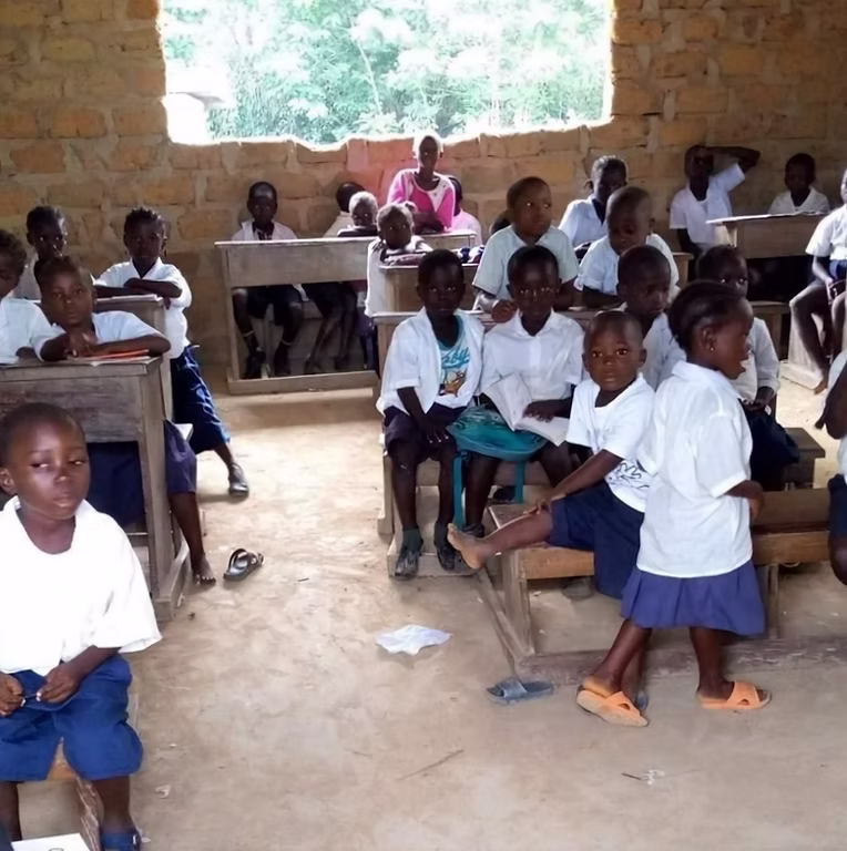 Students seated at a new wooden bench in Liberia